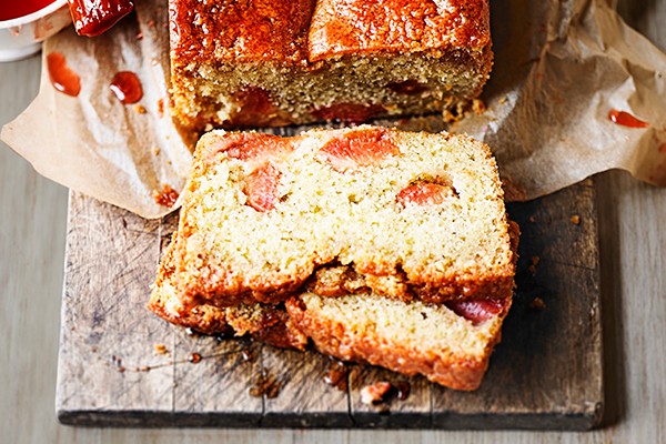 Plum loaf cake, sliced on a board