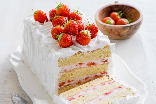 Strawberry layer cake with merigue icing, topped with strawberries