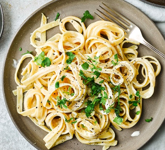 Two plates of Fettuccine Alfredo