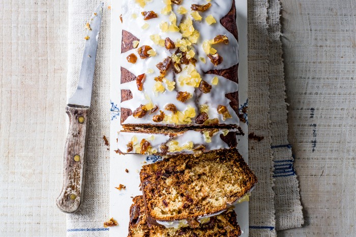 Ginger and date loaf cakentopped with icing and chopped ginger