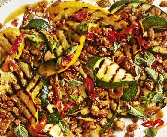 BBQ courgette with labneh and savoury granola A platter of charred courgettes on a linen napkin